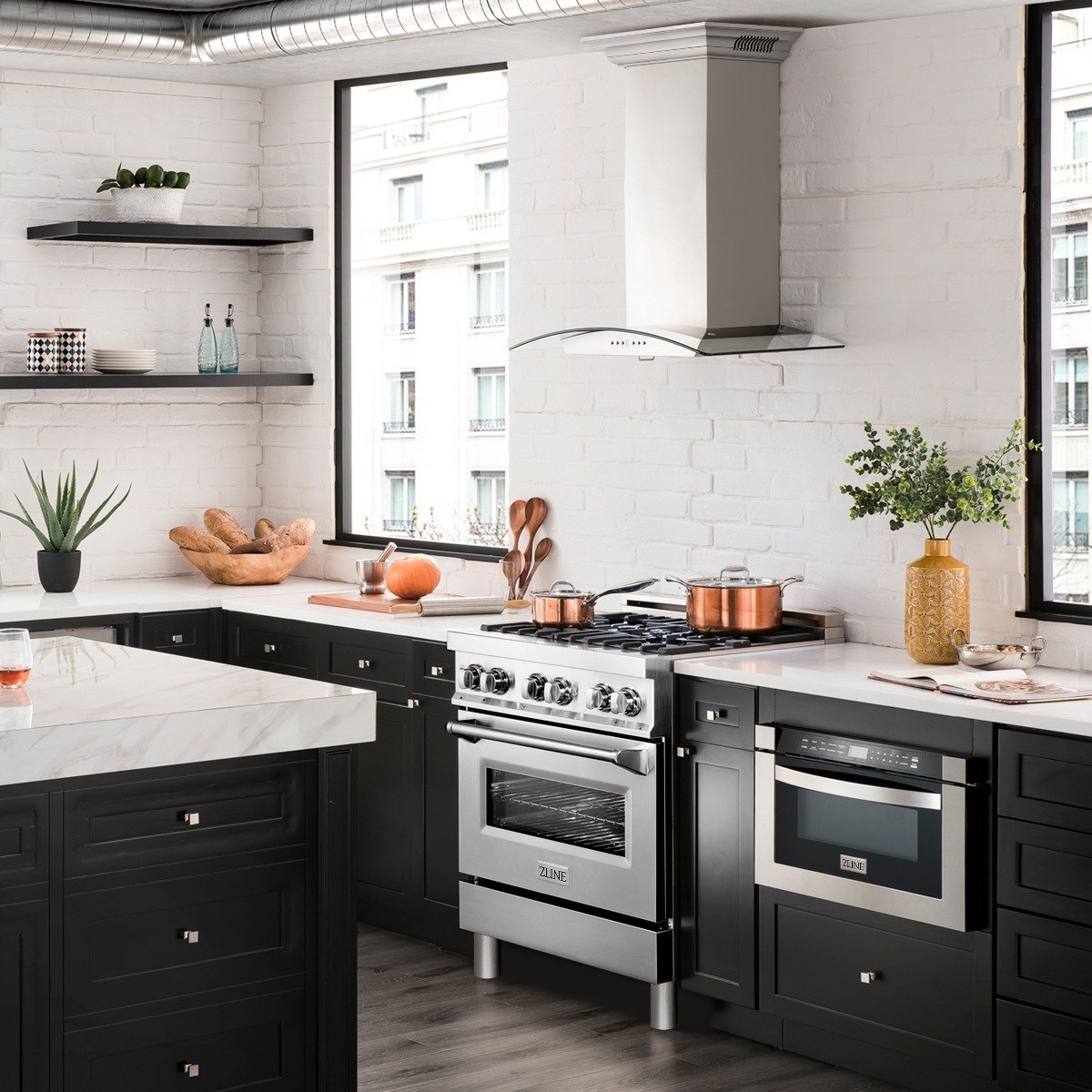 Stainless steel wall-mount range hood installed above a kitchen cooktop