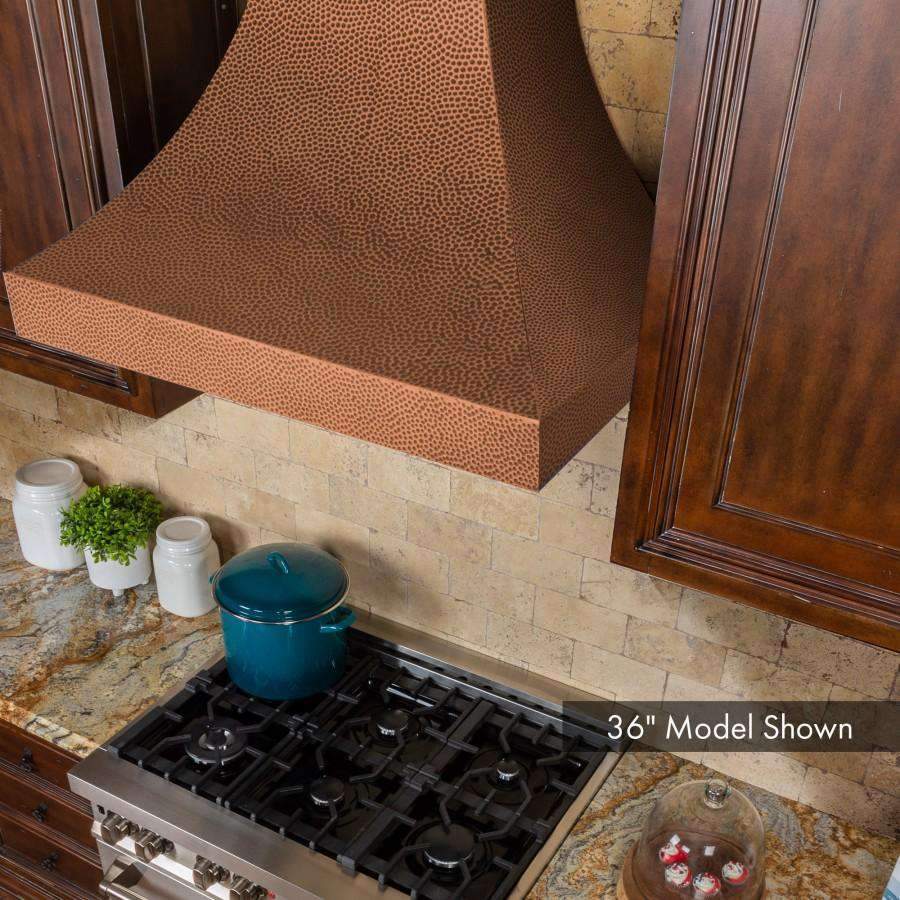 Copper hammered-finish wall range hood over cooktop with stainless vent and baffle rails