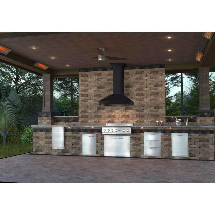 Designer wall range hood over outdoor kitchen cooktop, with surrounding cabinets and stone wall