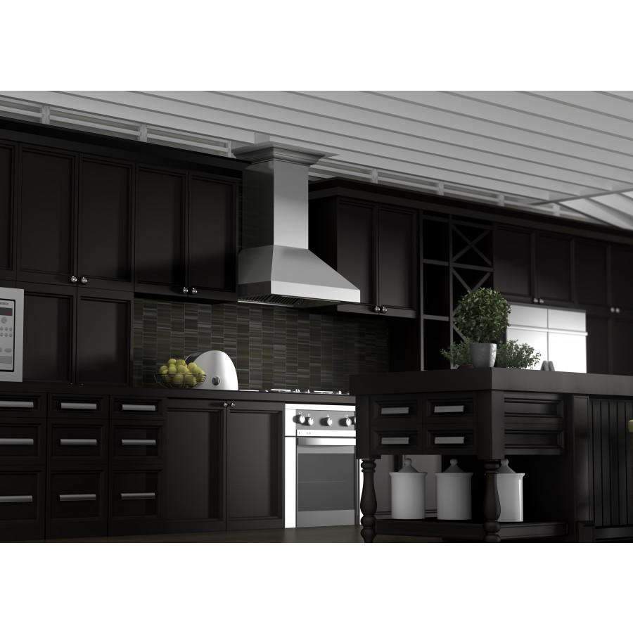 Stainless steel wall chimney range hood installed over a range in a kitchen