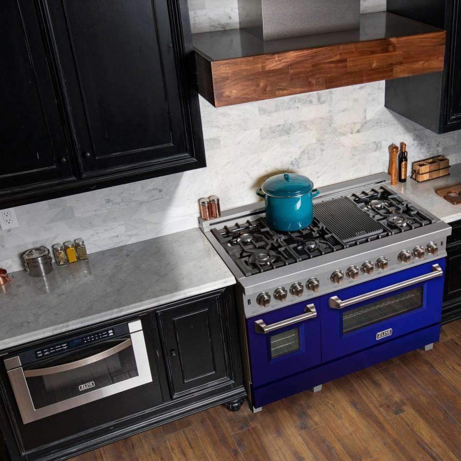 Dual fuel range with blue doors, stainless knobs, and black cooktop burner grates