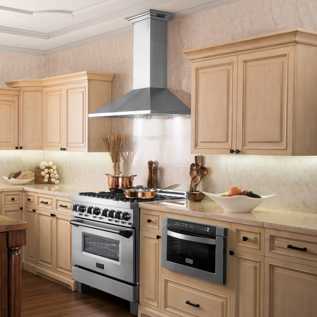 Stainless steel wall mount range hood above a cooktop with chimney duct