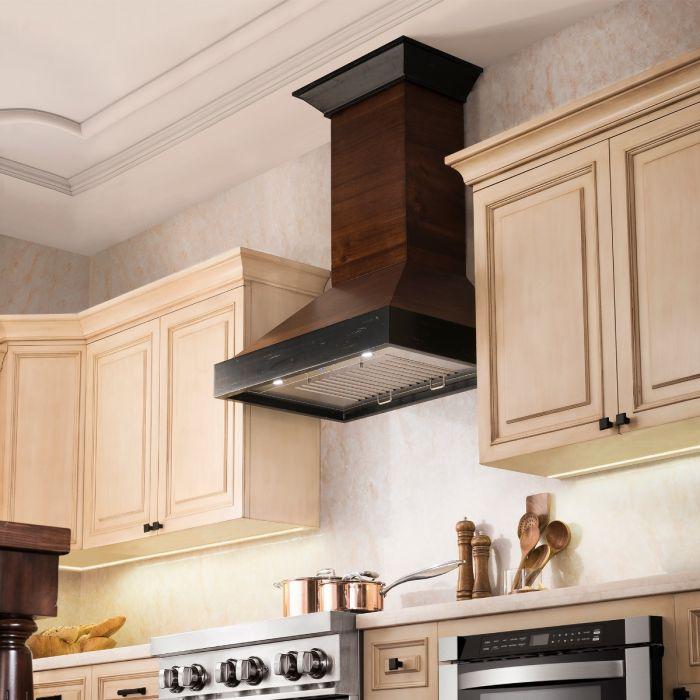 Wood wall range hood above stovetop with stainless vent panel
