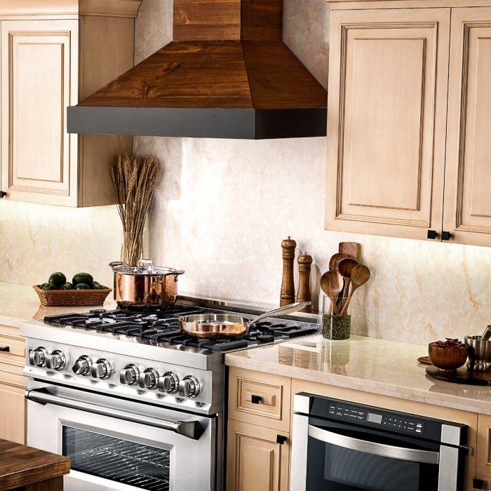 Wood and stainless wall range hood above a gas cooktop with control panel