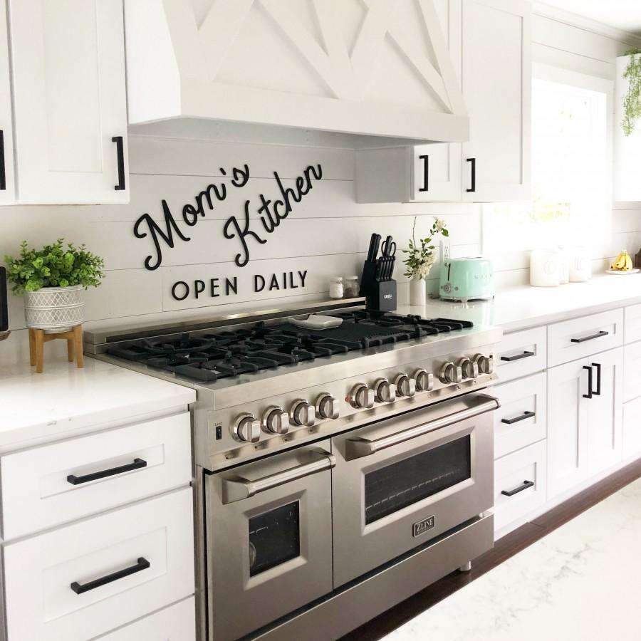 Stainless steel dual fuel range with black cooktop grates and double oven doors