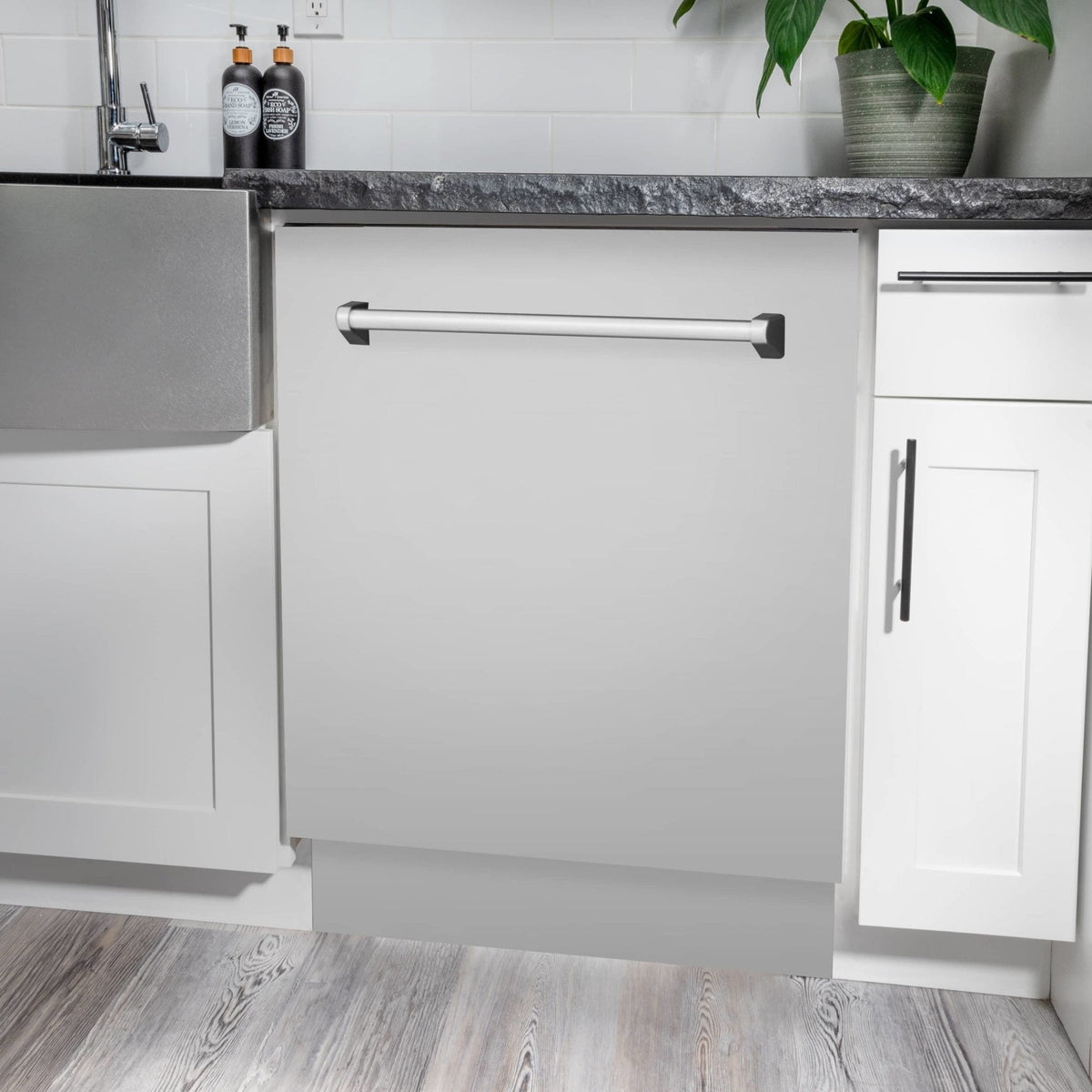 Built-in dishwasher in white cabinet with stainless countertop and front access panel