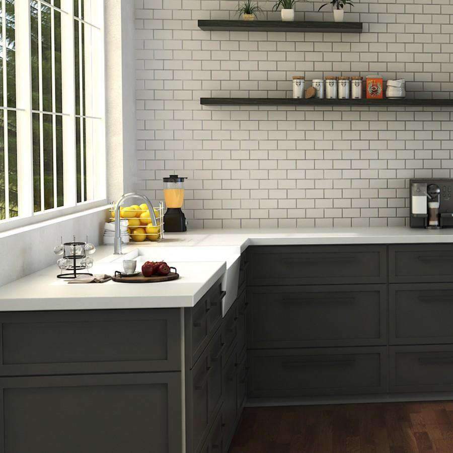 Chrome kitchen faucet with tall curved spout over sink