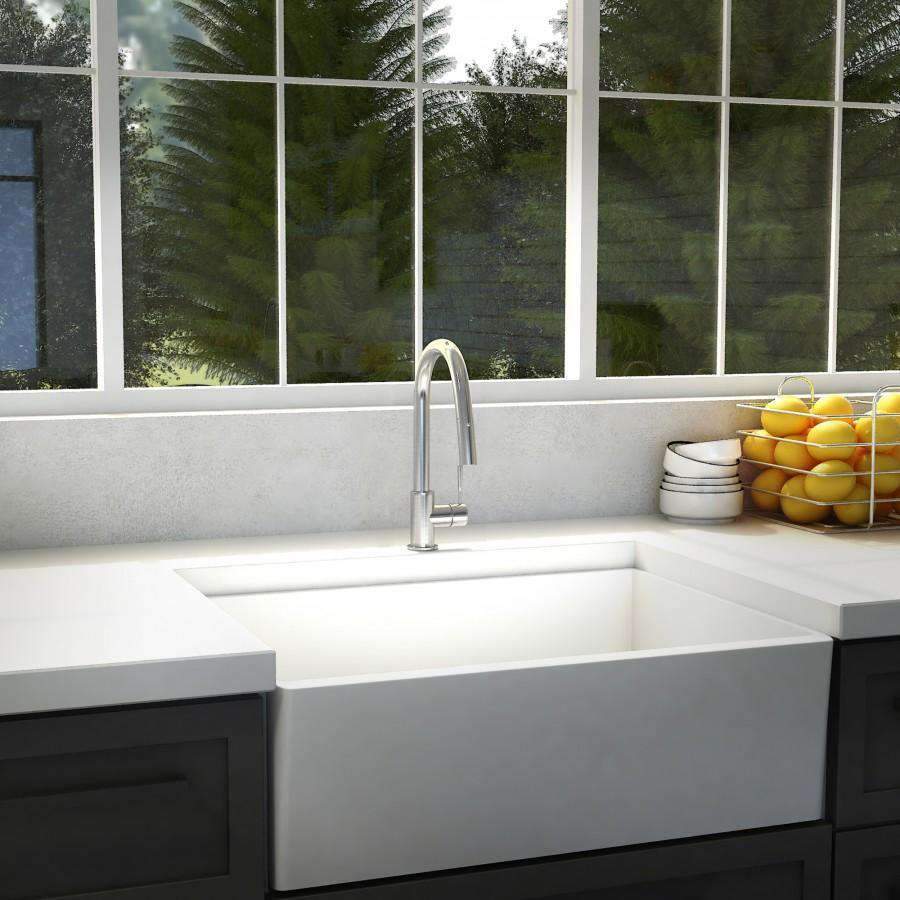 Chrome kitchen faucet with tall curved spout mounted on sink