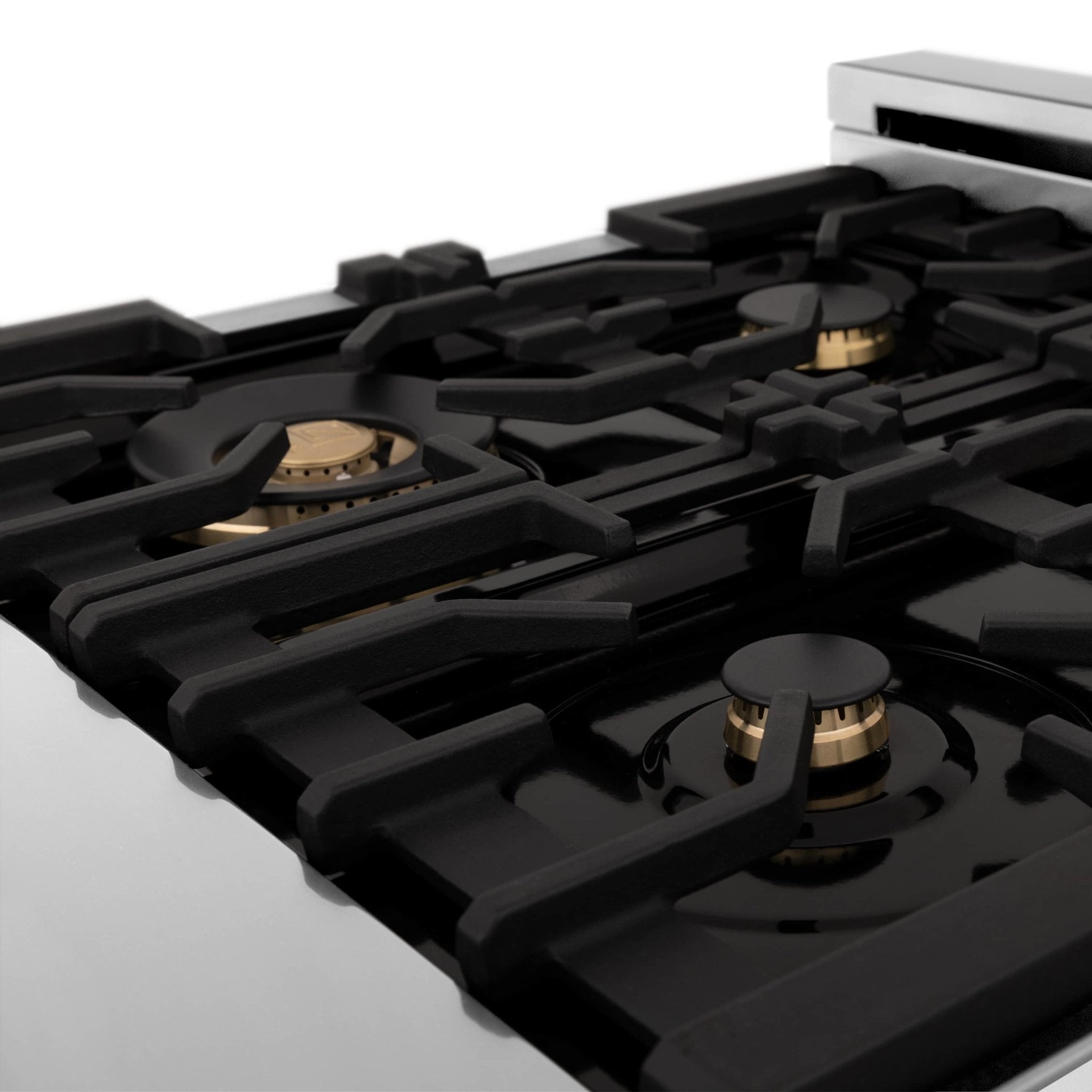 Dual fuel range cooktop with black burner grates and gold burner caps on display