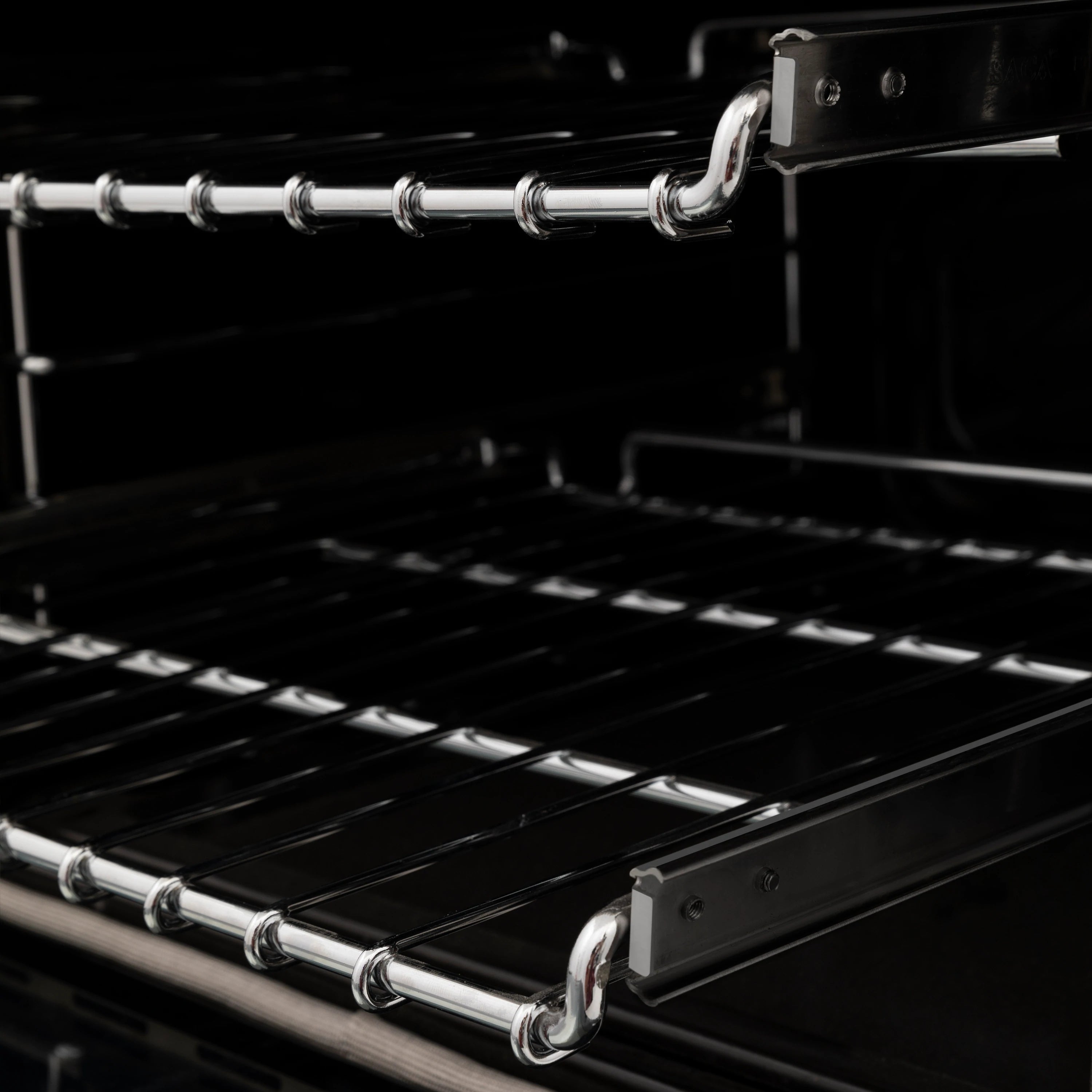 Black oven interior with chrome racks and rail supports