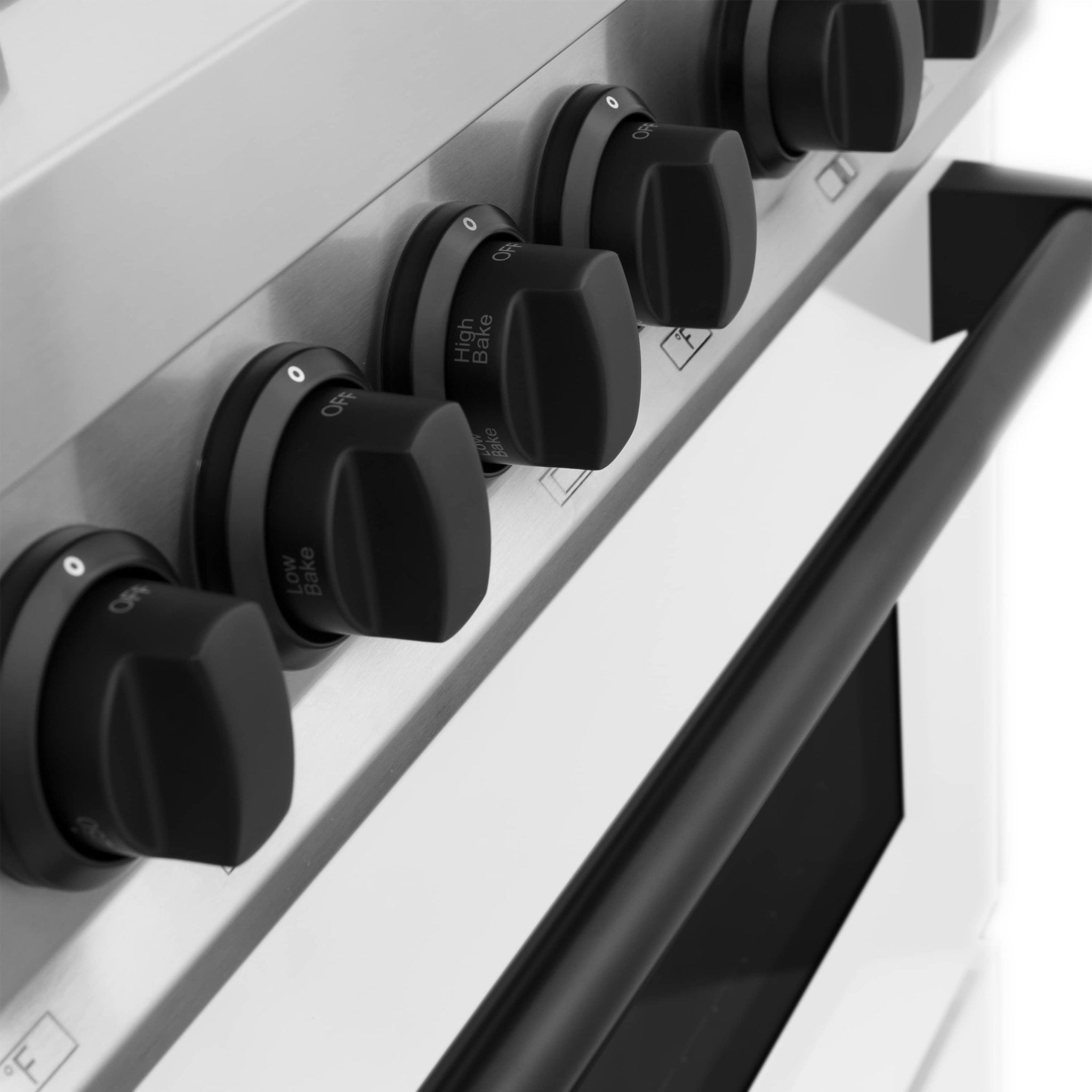 Black control knobs on a white range panel with burner label markings