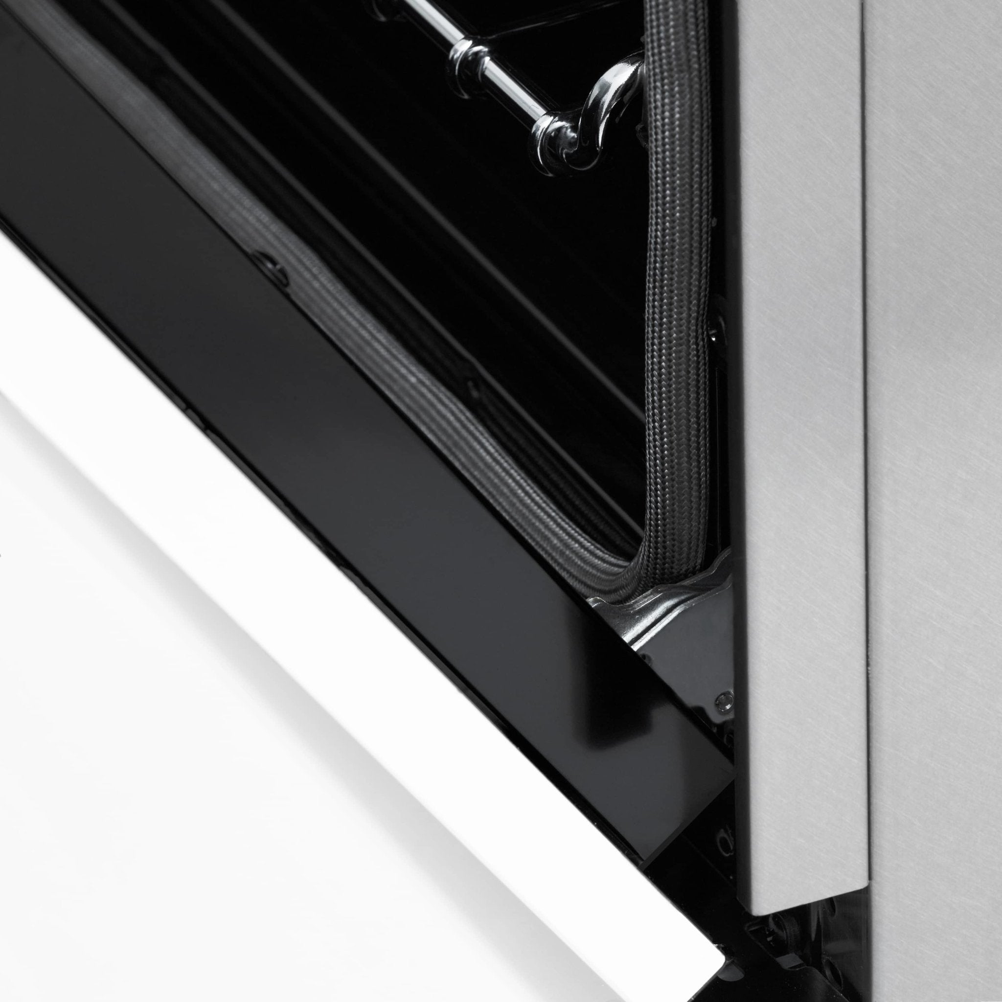 Dual fuel range oven door corner with black gasket trim and chrome handle