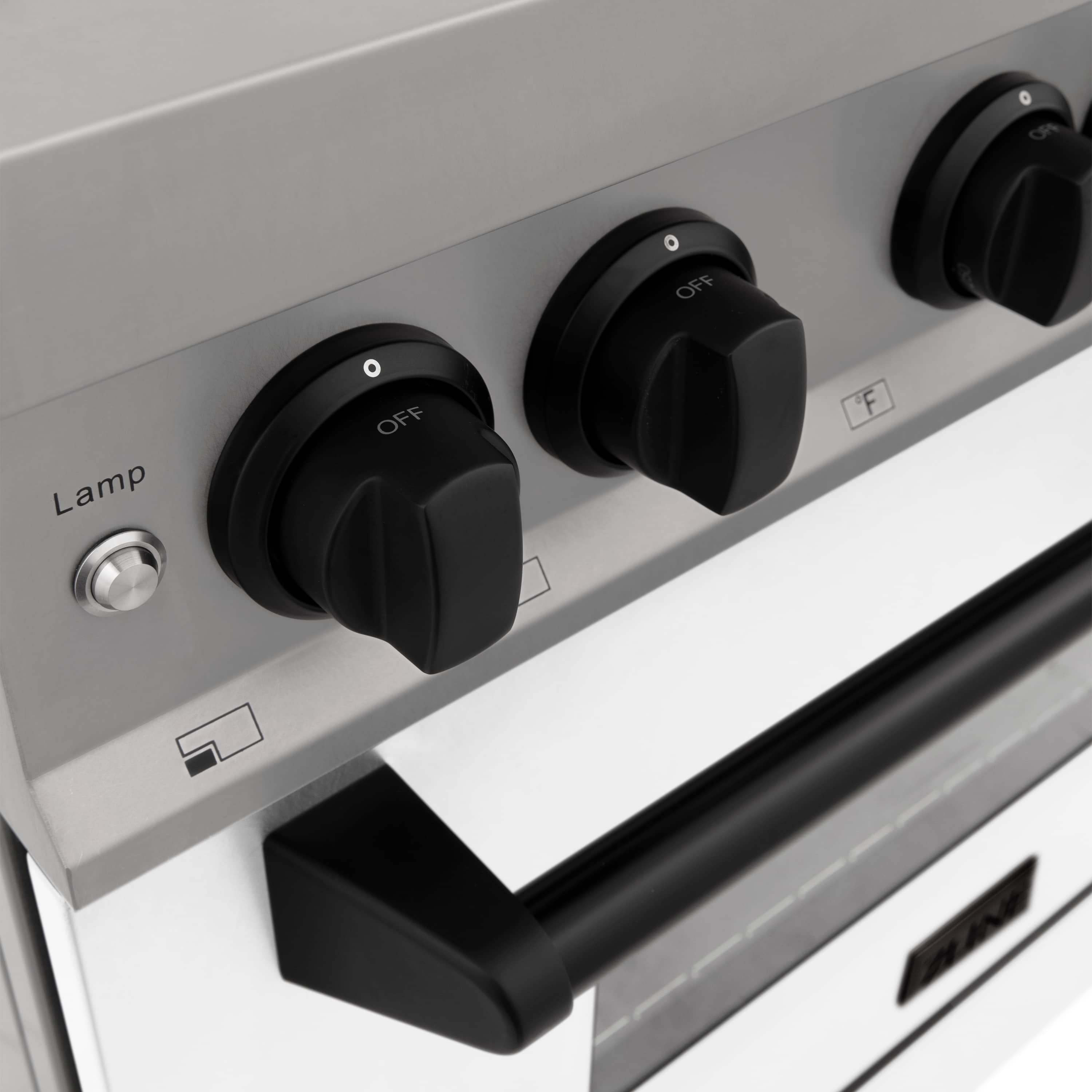 Range control panel with black knobs labeled Lamp and Off