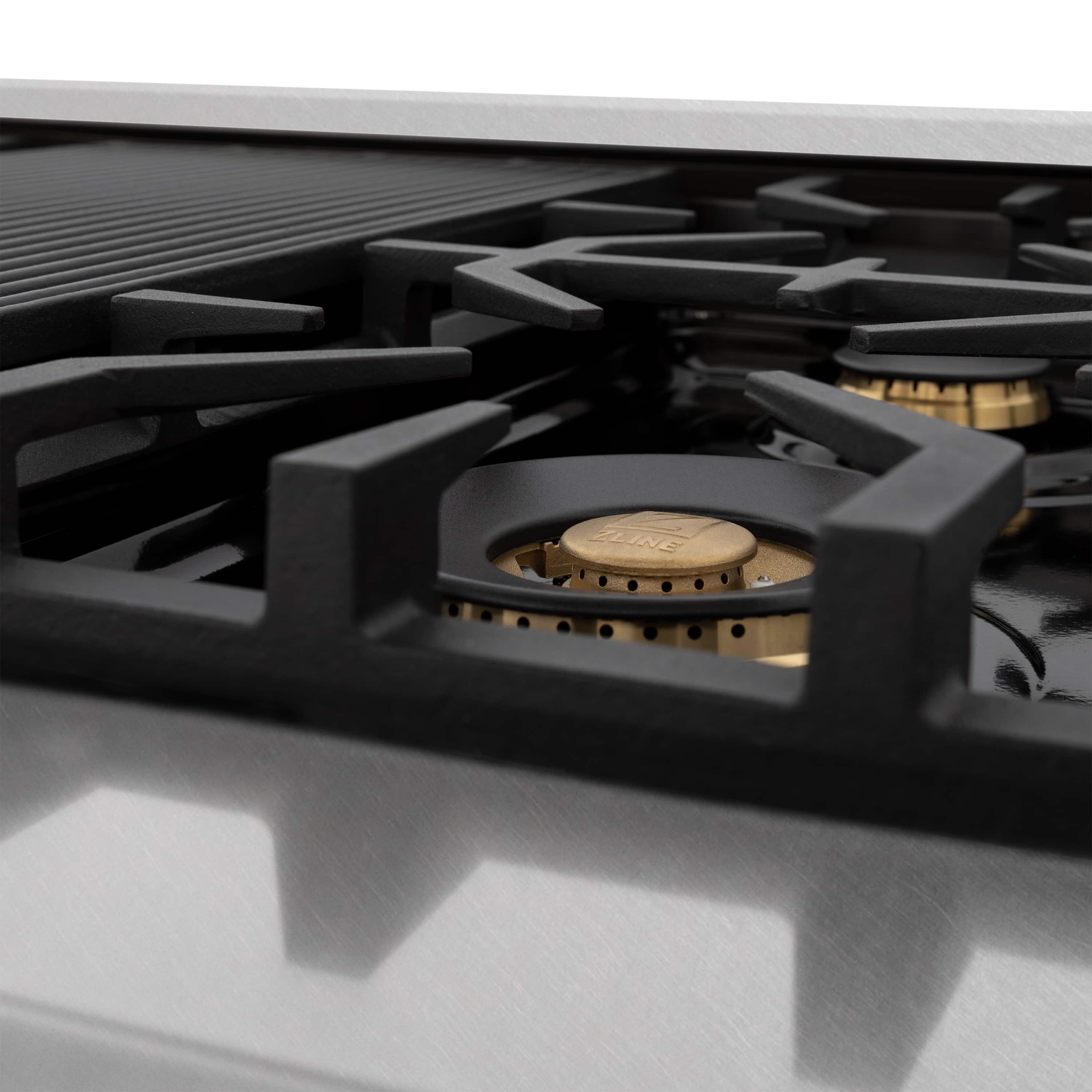 Black gas burner grate with bronze-colored burner cap