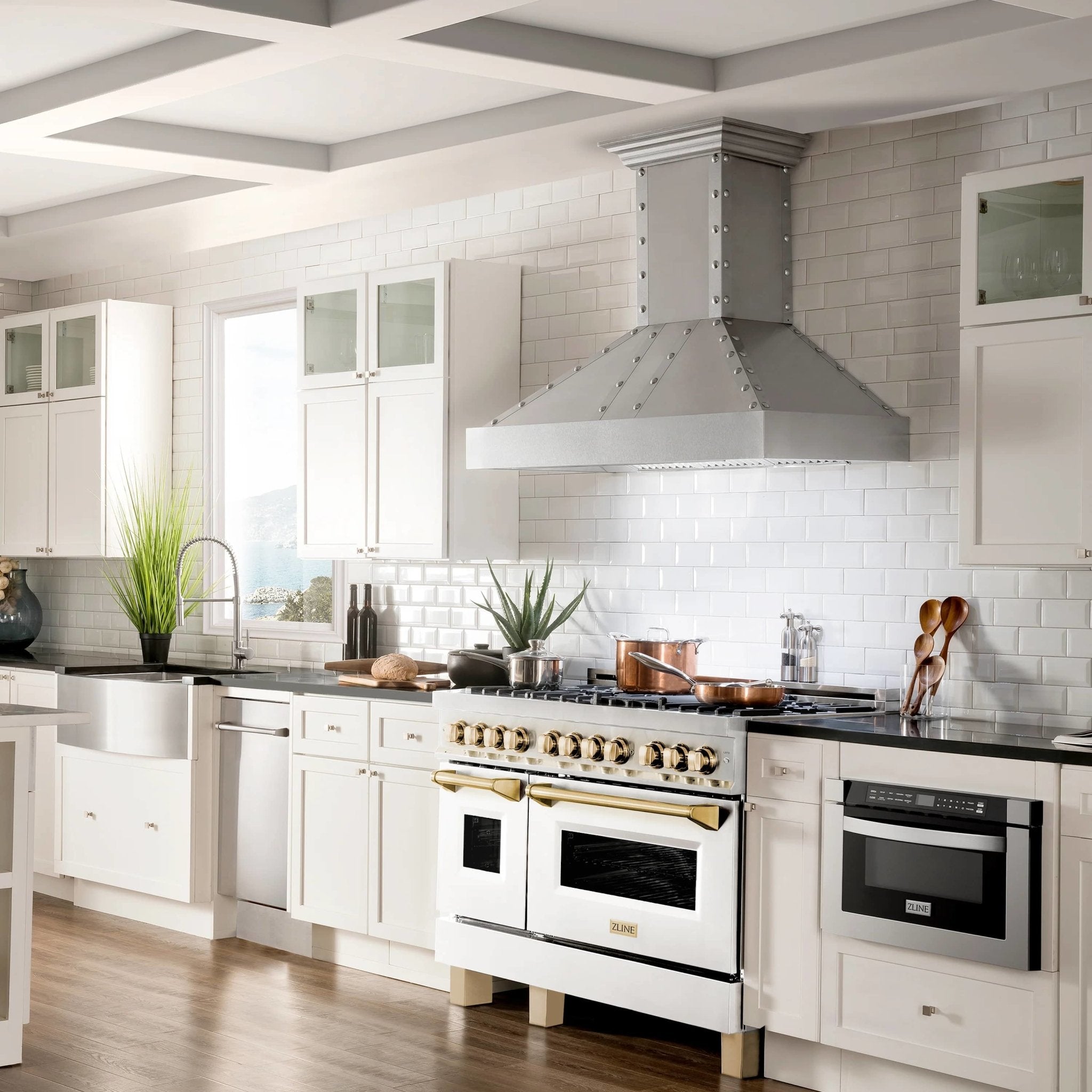 Stainless dual fuel range with white matte doors and gold-accented controls