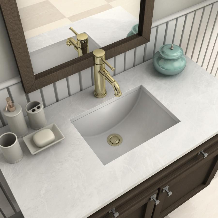 Polished gold tall bath faucet with curved spout and sink drain fitting