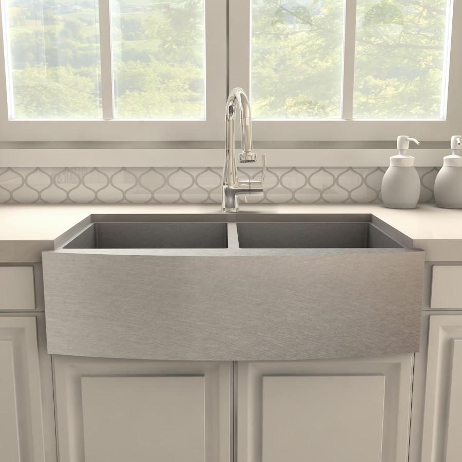 Chrome kitchen faucet with tall arched spout mounted above large sink