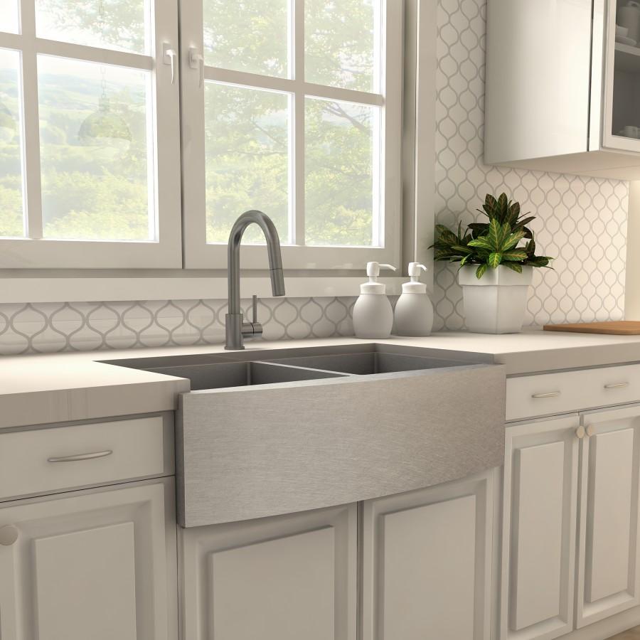 Gun metal kitchen faucet above farmhouse-style double basin