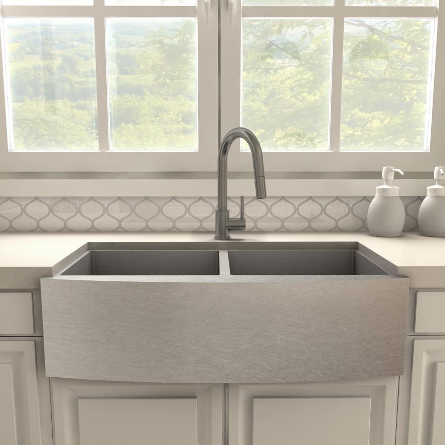 Gun metal kitchen faucet centered over double sink basin