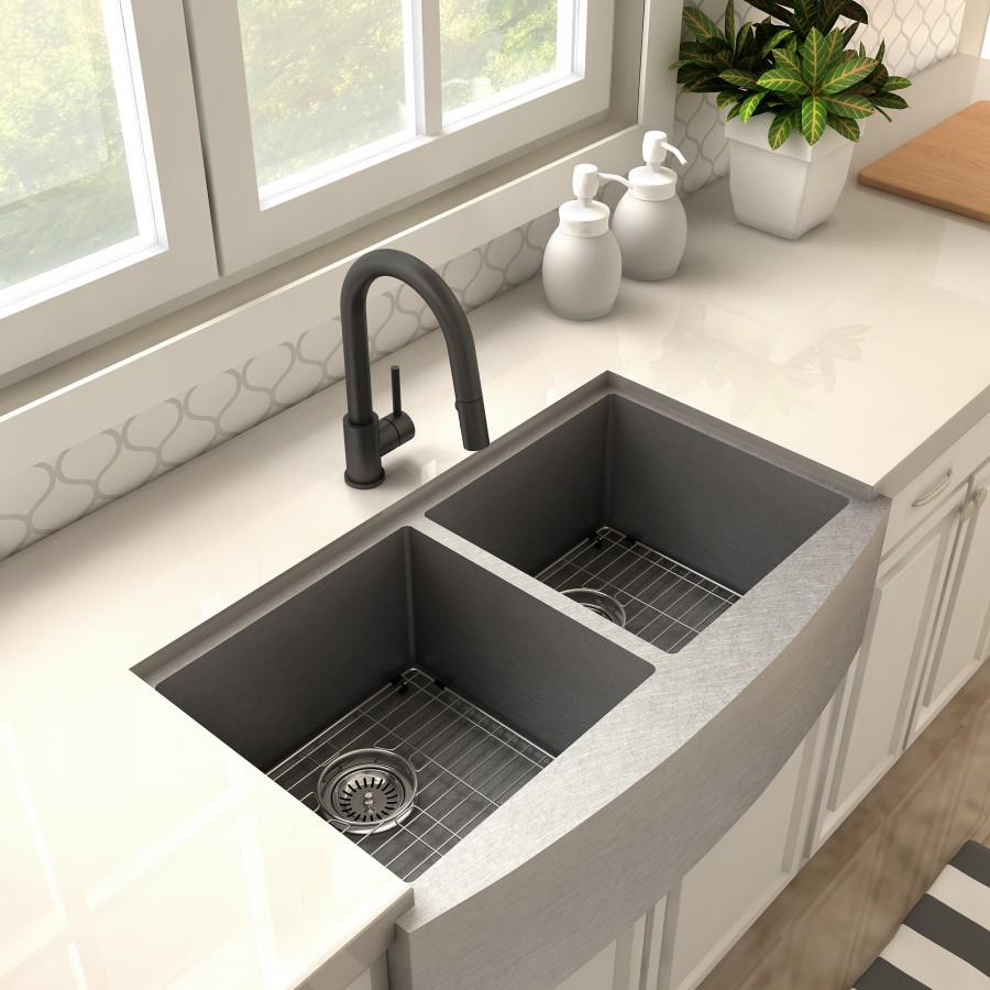 Matte black kitchen faucet over a double sink with drain strainers and fitted grates