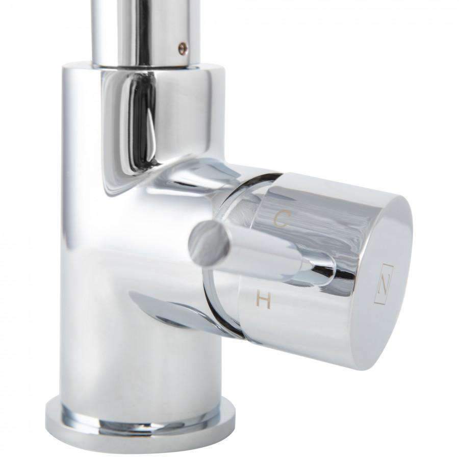 Close-up of chrome faucet handle and spout base with glossy reflective finish