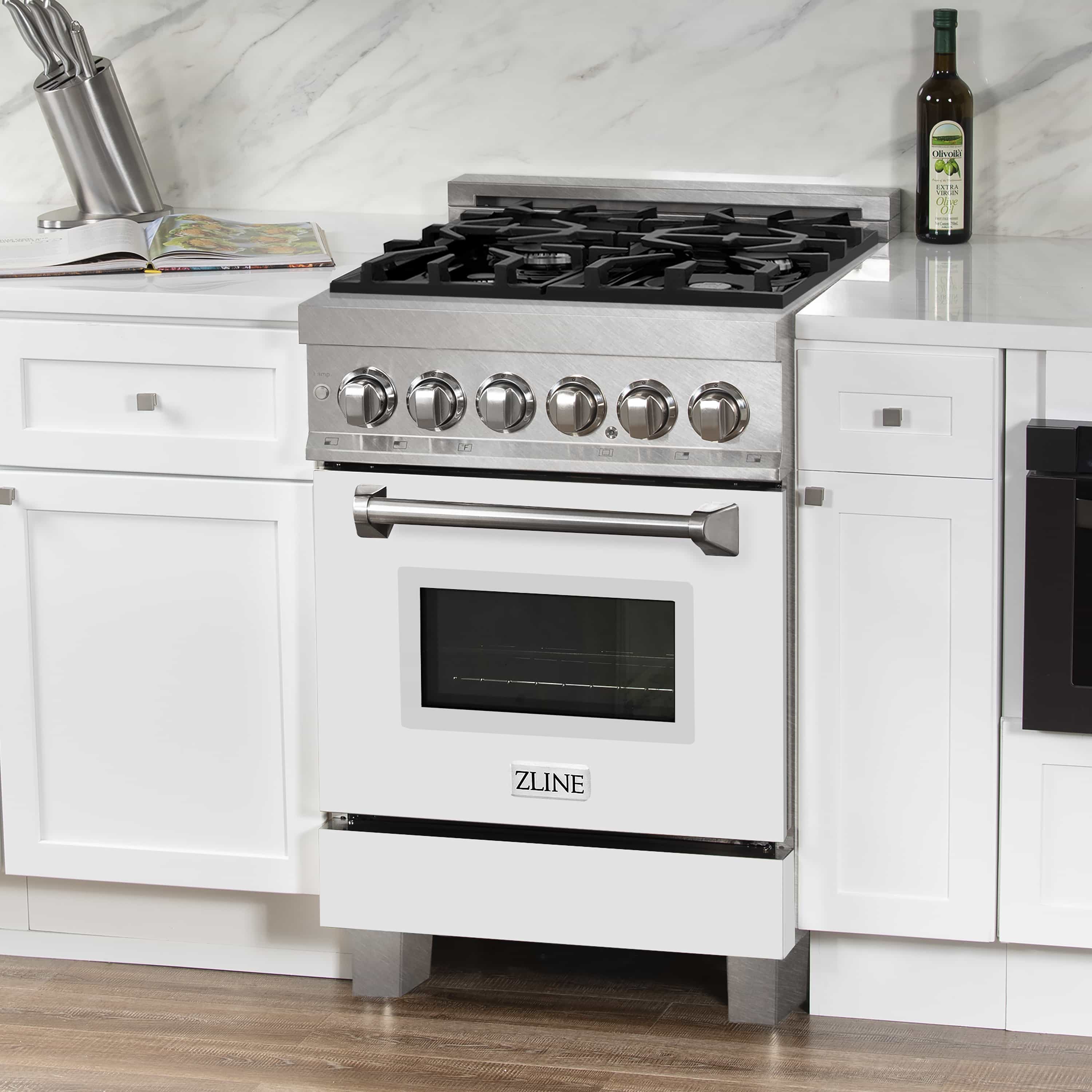Freestanding dual fuel range with black burner grates, round knobs, and white oven door