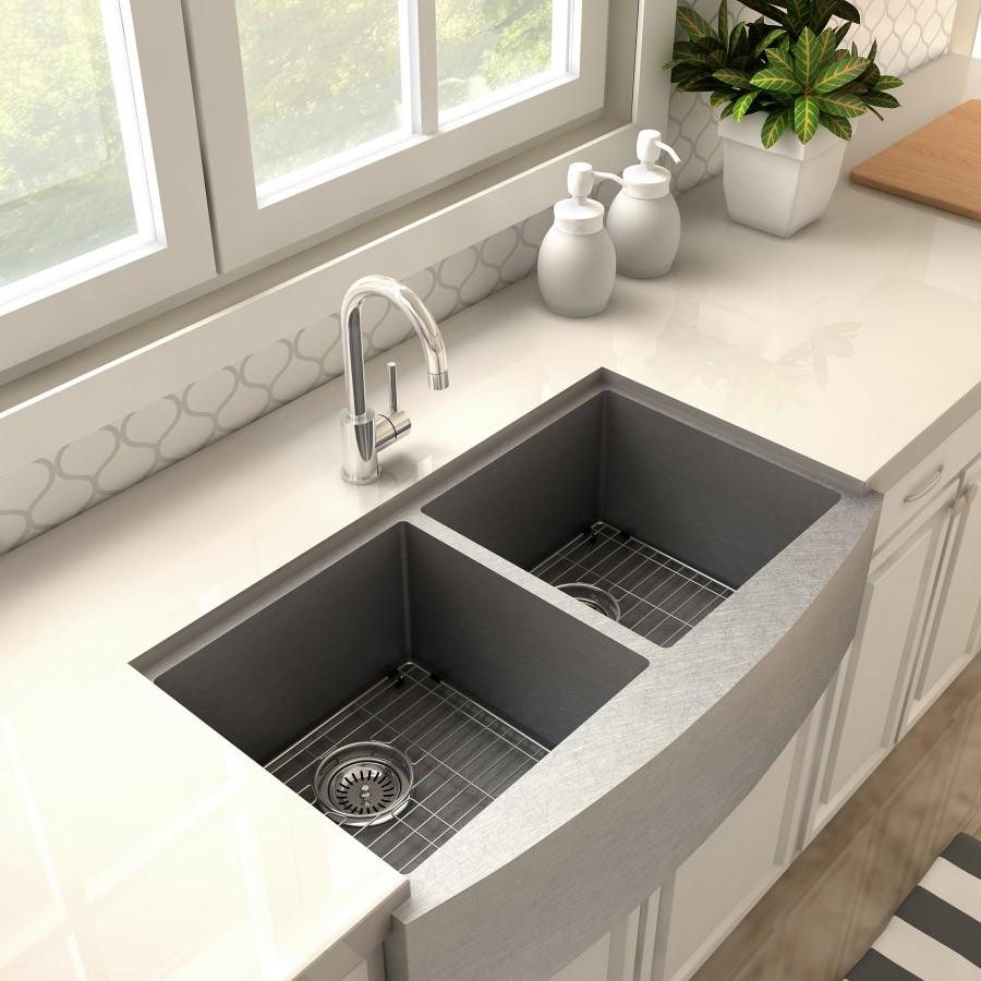 Chrome kitchen faucet with arched spout and single lever, centered above sink.