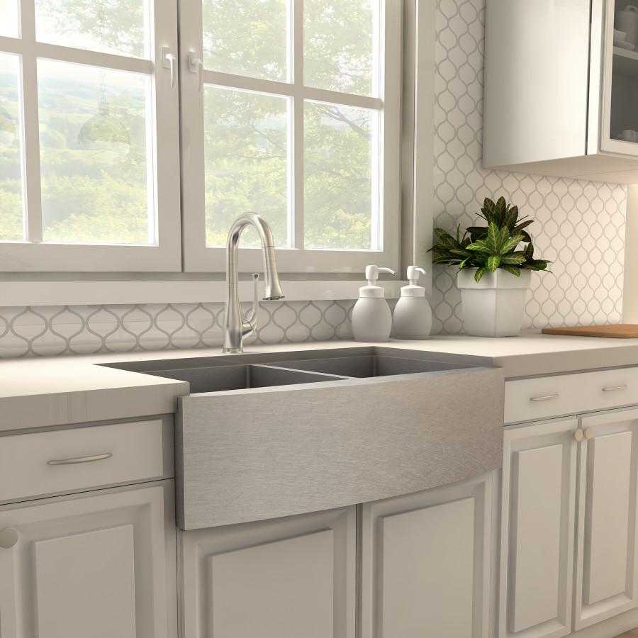 Brushed nickel kitchen faucet over undermount double sink with side handles