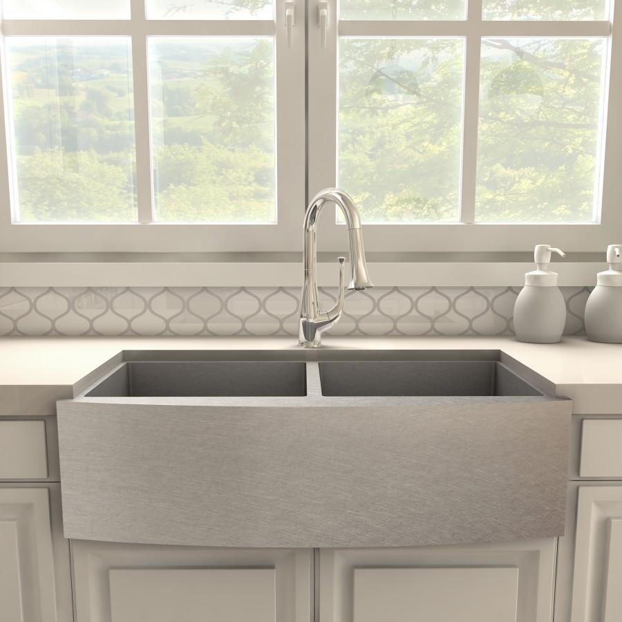 Chrome kitchen faucet over single-basin sink with curved arched spout