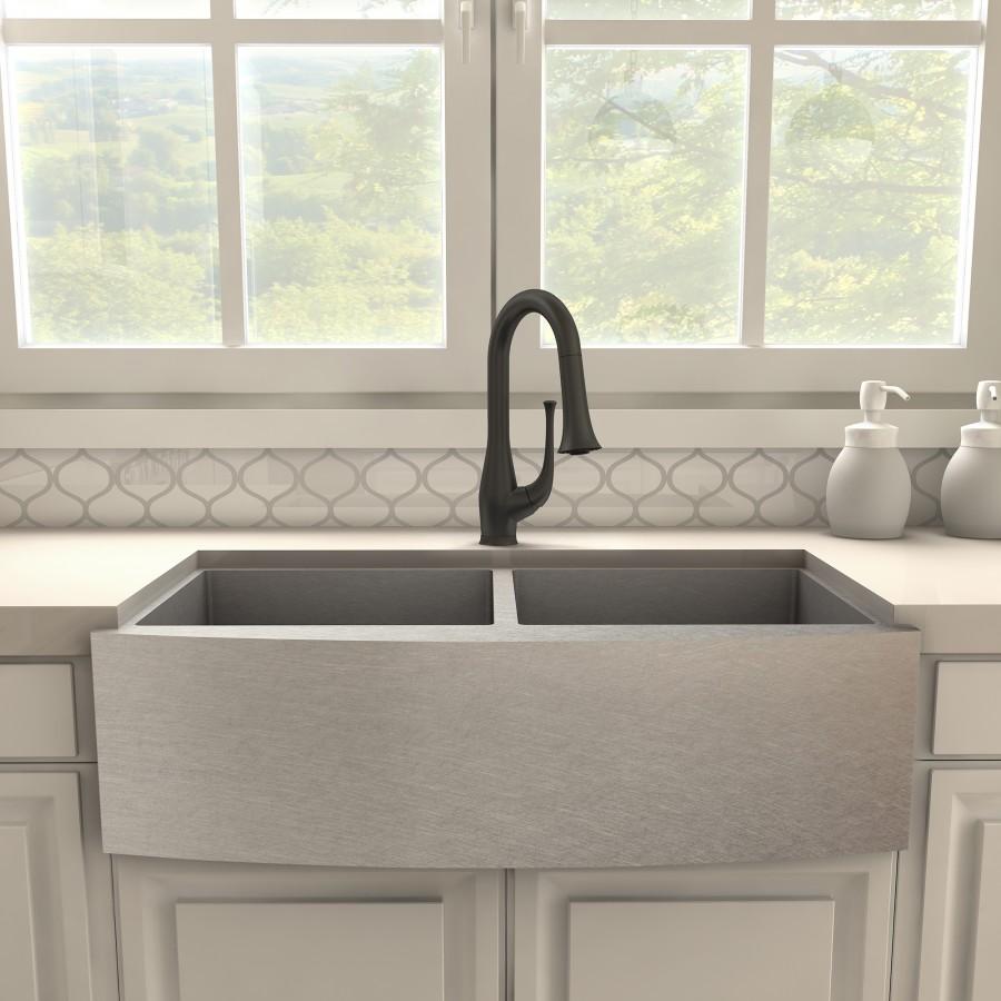 Matte black kitchen faucet mounted above a double farmhouse sink