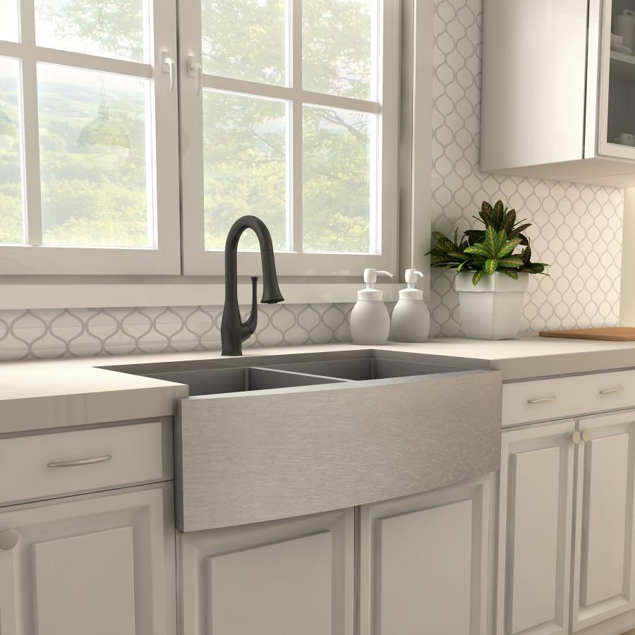 Matte black kitchen faucet above a double sink with soap bottles on the counter