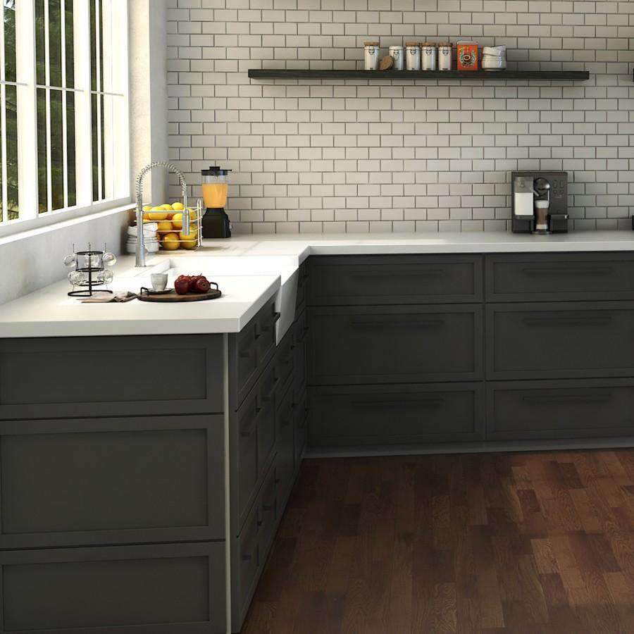 Chrome kitchen faucet with arched sprayer on a white countertop and sink