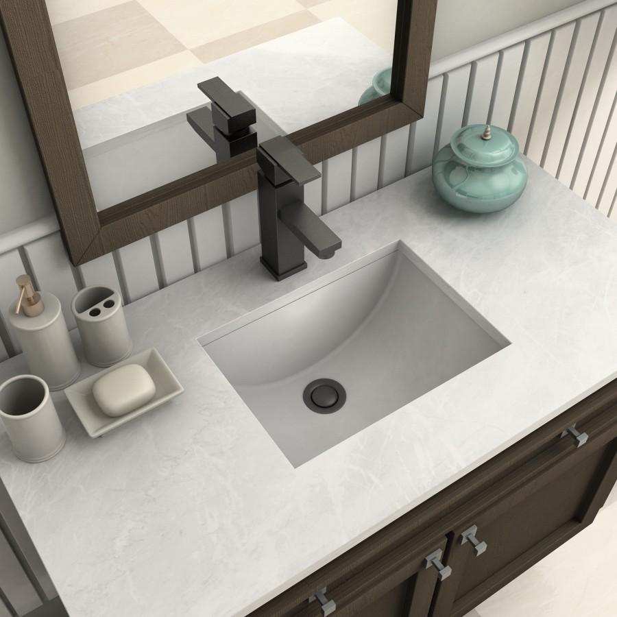 Matte black bath faucet with square handle and spout over rectangular sink