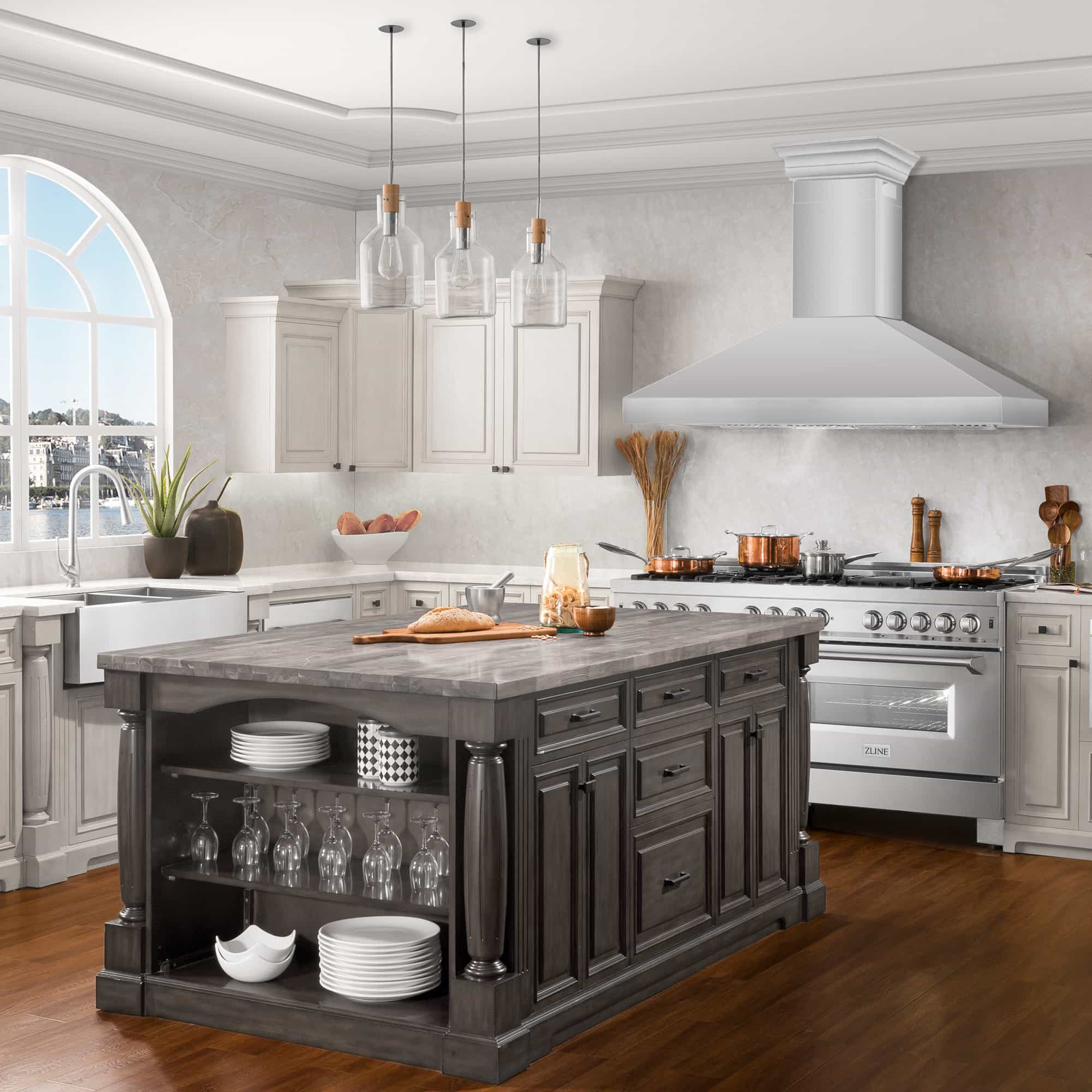 Stainless steel wall mount range hood with chimney stack and wide canopy above cooktop