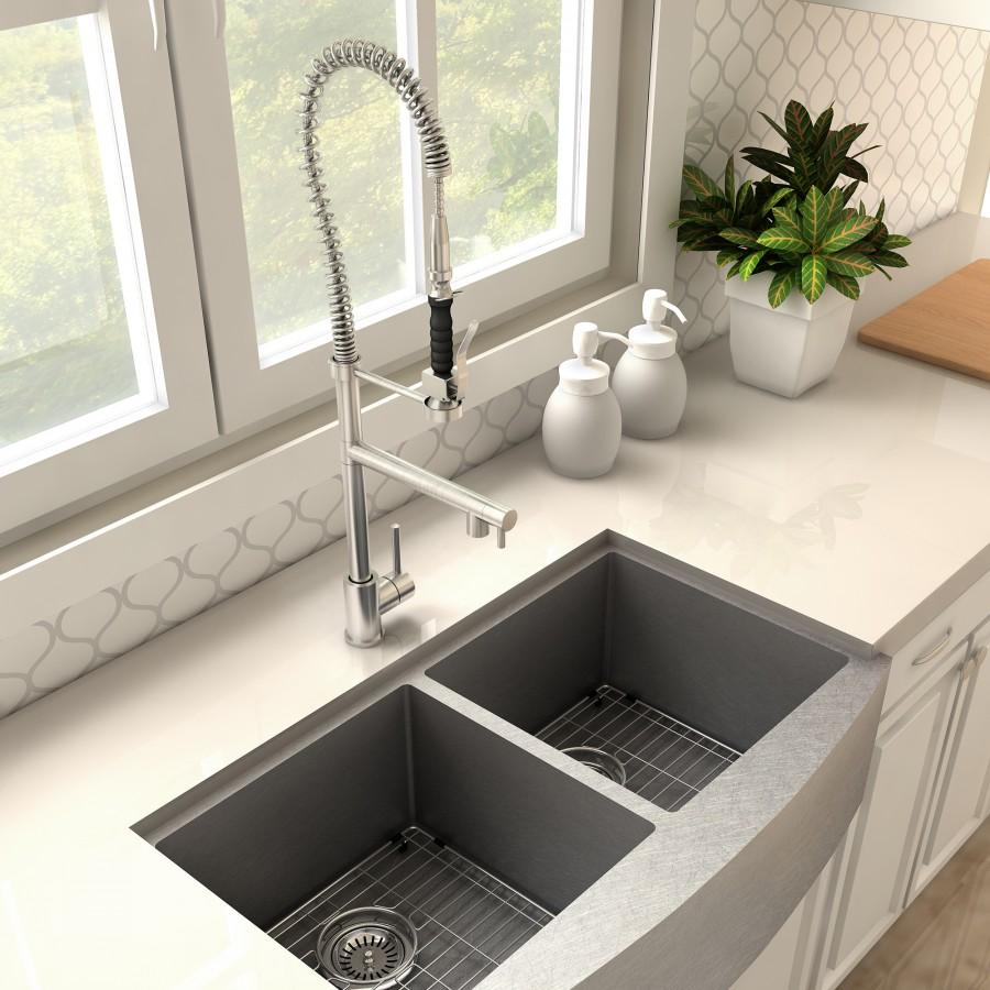 Brushed nickel kitchen faucet with coiled spring hose over double sink basins