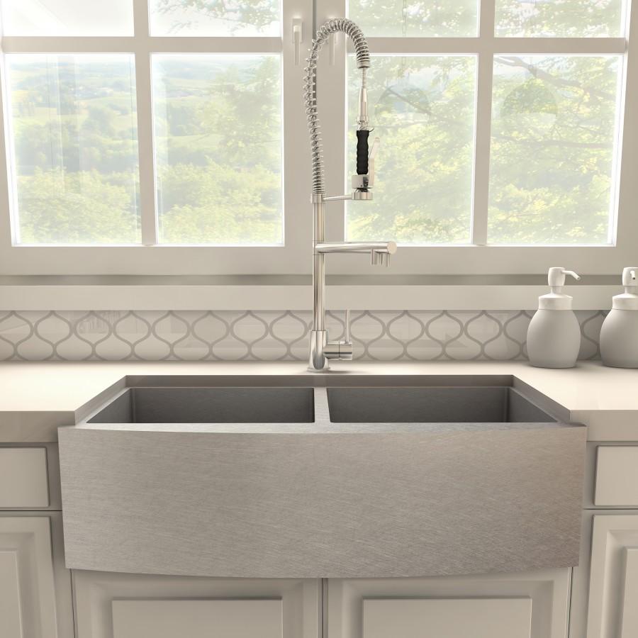 Chrome high-arc kitchen faucet with coiled spring sprayer hose and side lever