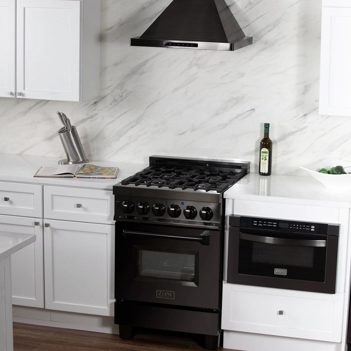 Black range hood above cooktop with built-in LED lighting