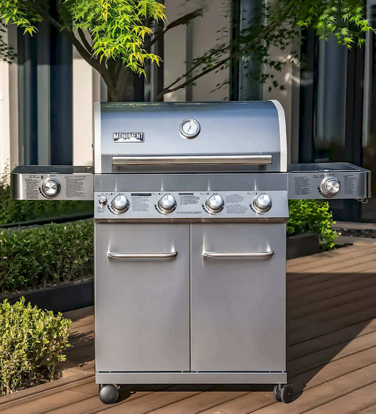Stainless steel propane gas grill with side burner modules and cabinet doors