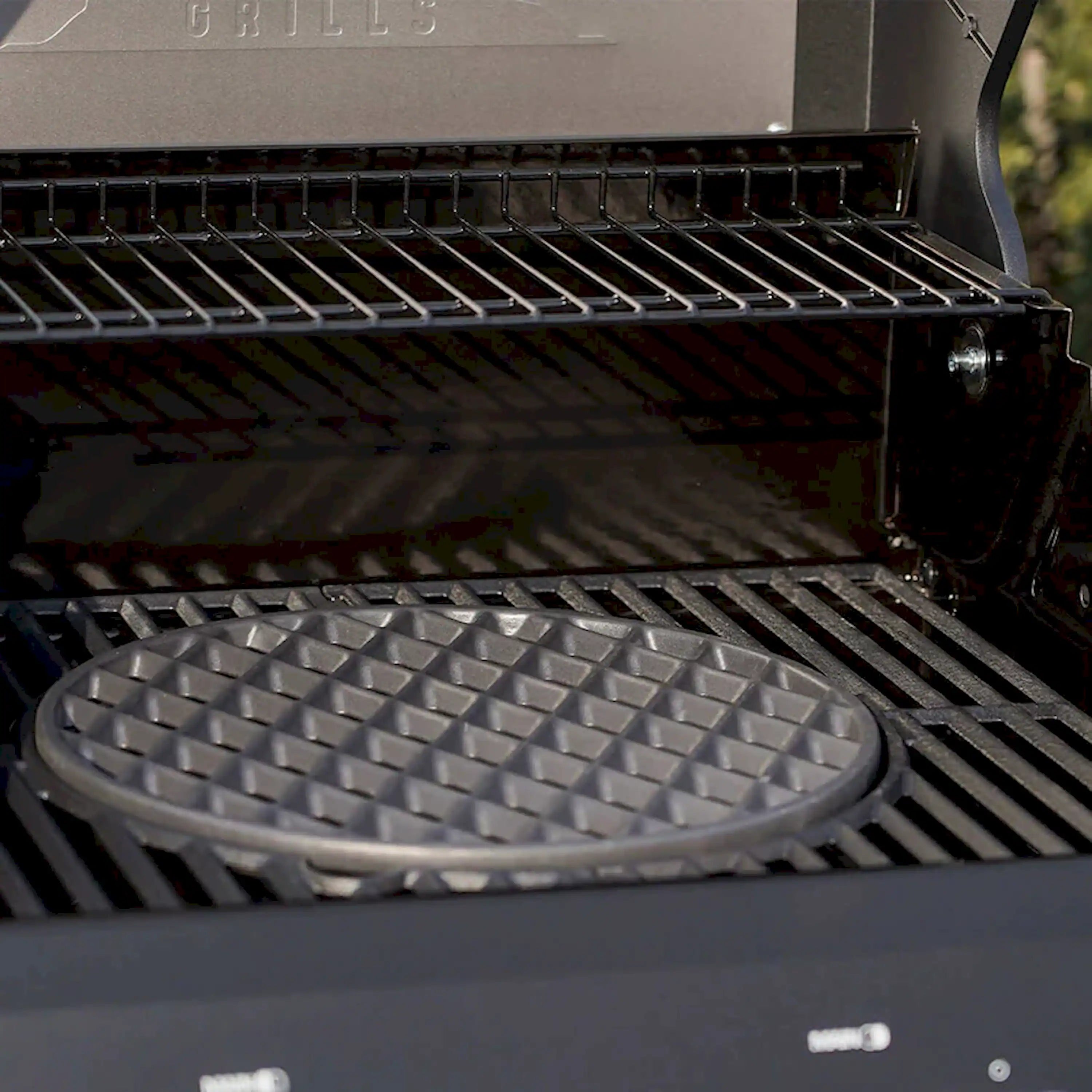 Cast iron grill grate with raised bars and circular insert, black finish