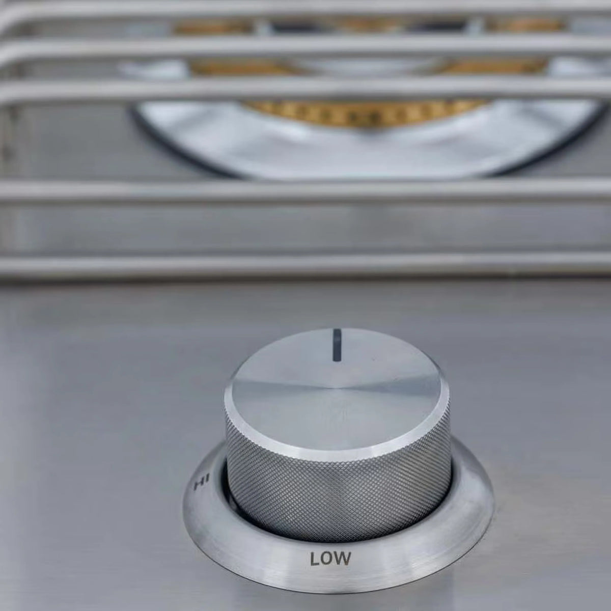 Stainless burner control knob labeled LOW on drop-in propane side burner