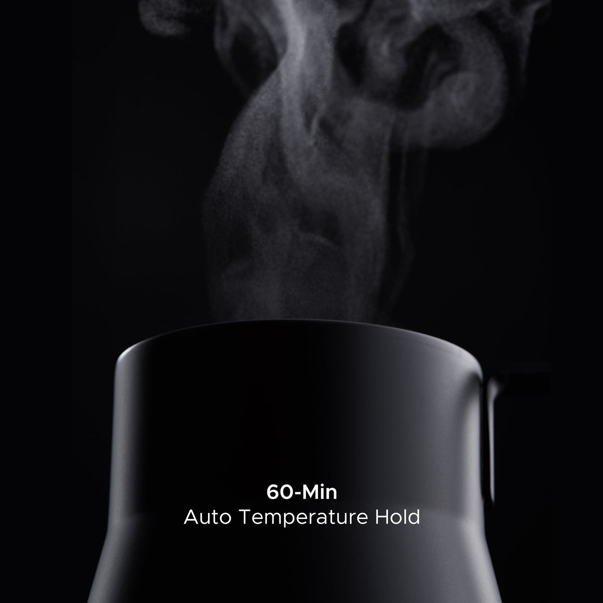 Matte black electric kettle releasing steam from the open top