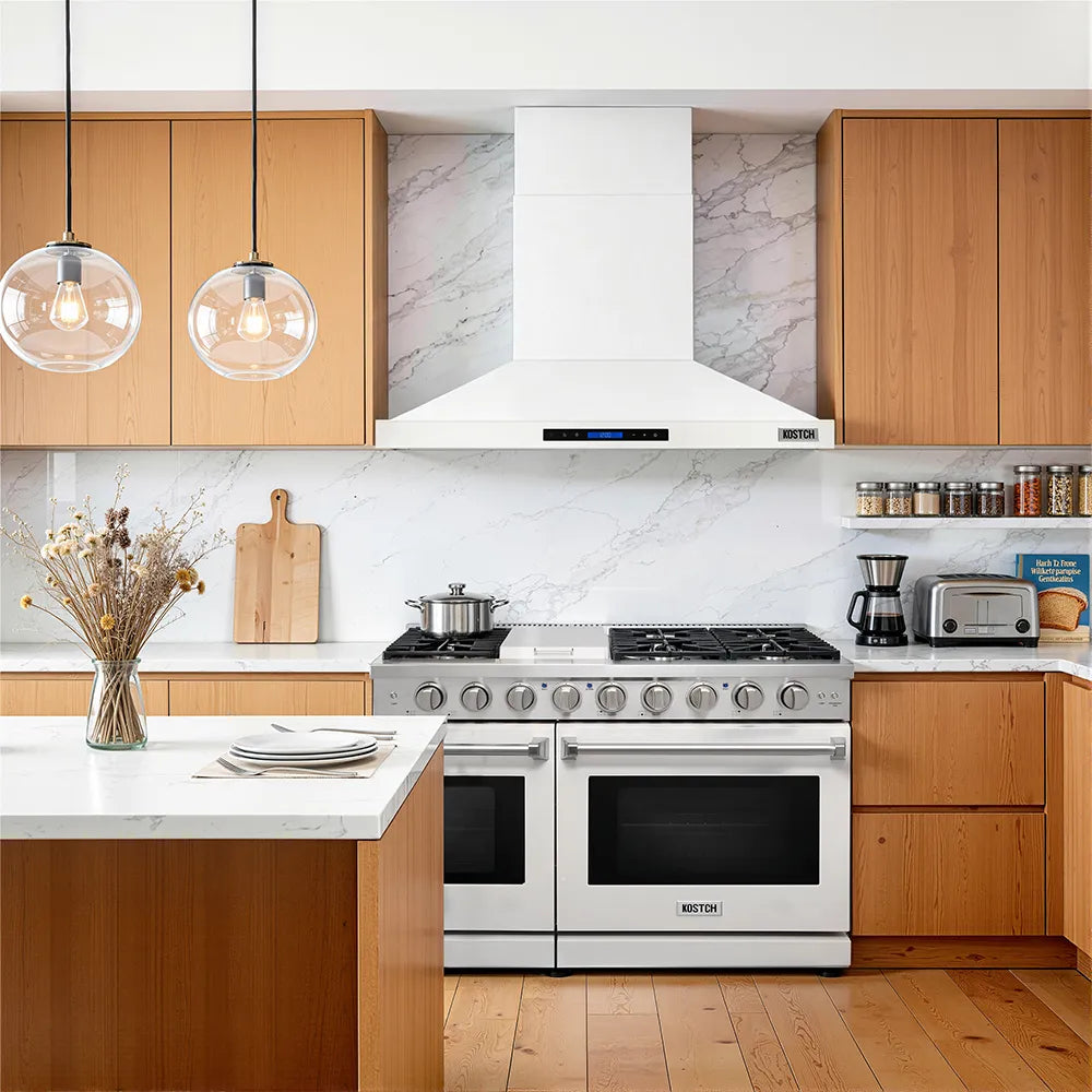 White convertible wall-mounted range hood with chimney-style canopy and baffle filters