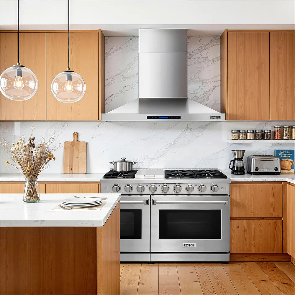 Stainless steel wall-mounted range hood over stove with control panel and lights