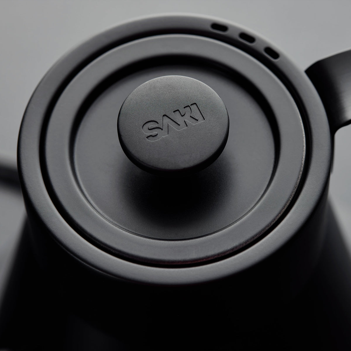 Matte black kettle base with centered power dial and textured edge