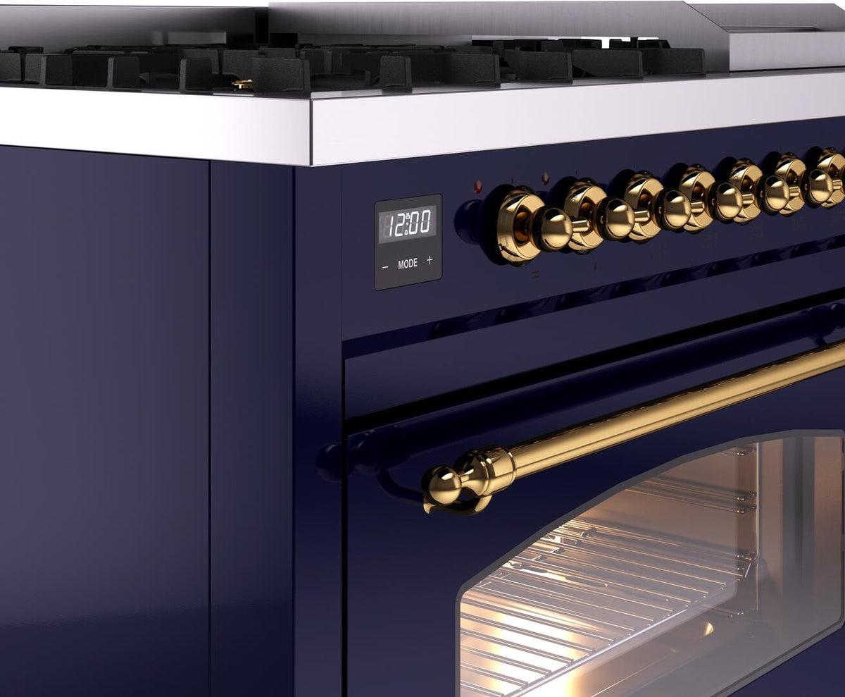 Midnight blue freestanding range control panel with brass knobs and display, oven handle