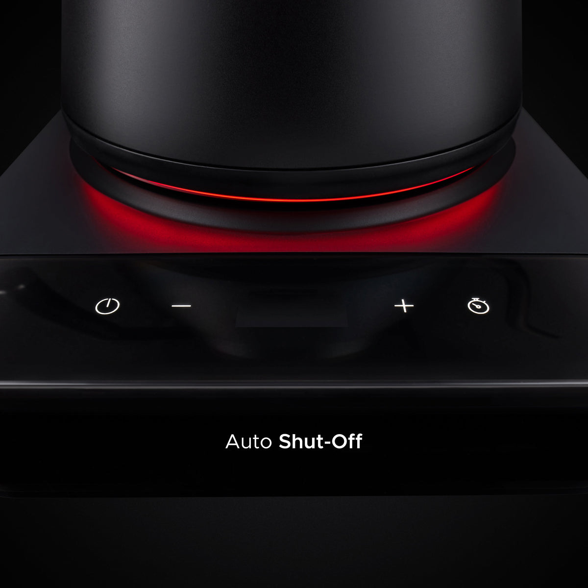 Matte black electric kettle base with glowing red heating ring and display