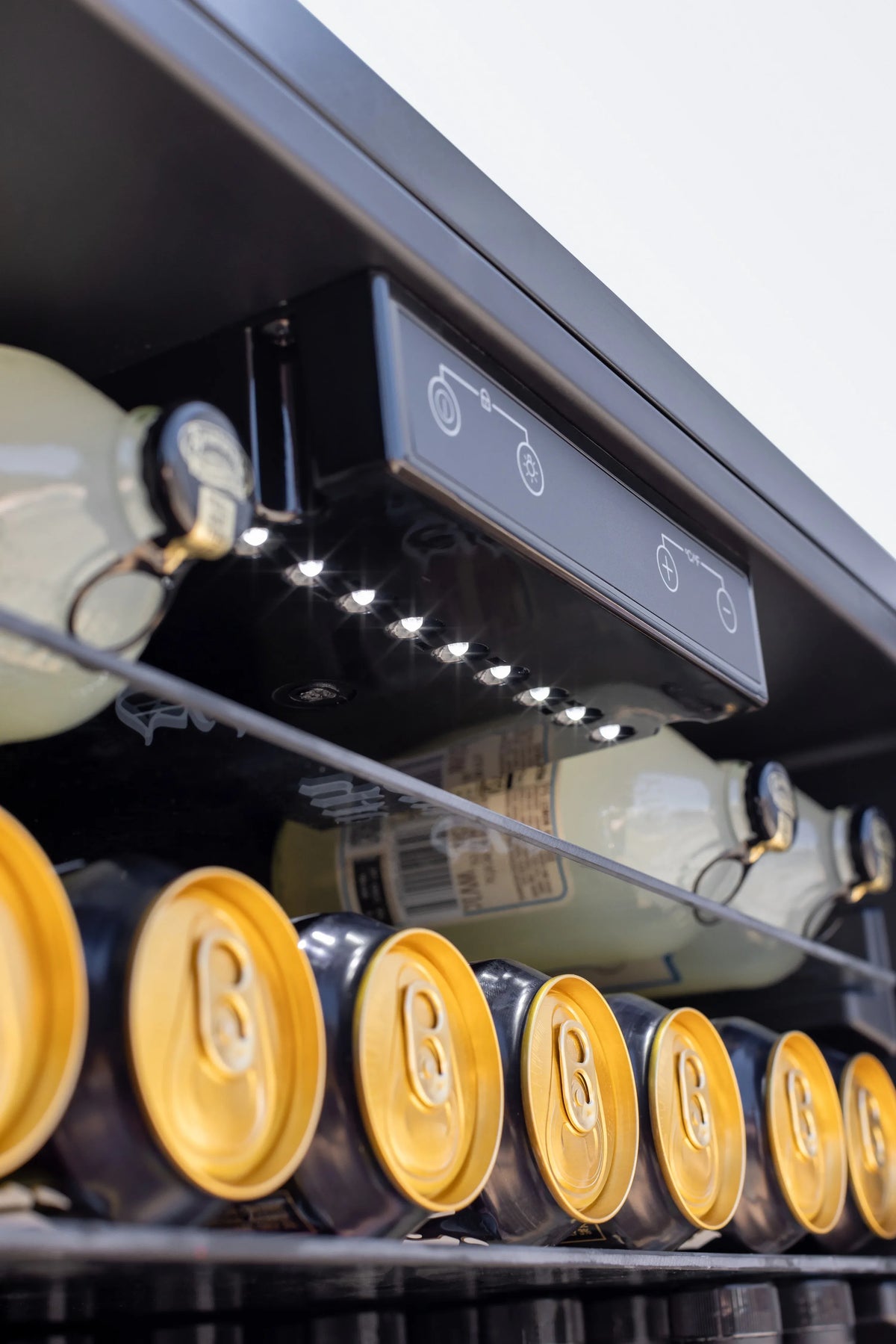 Outdoor fridge top interior with control panel and row of bright lights