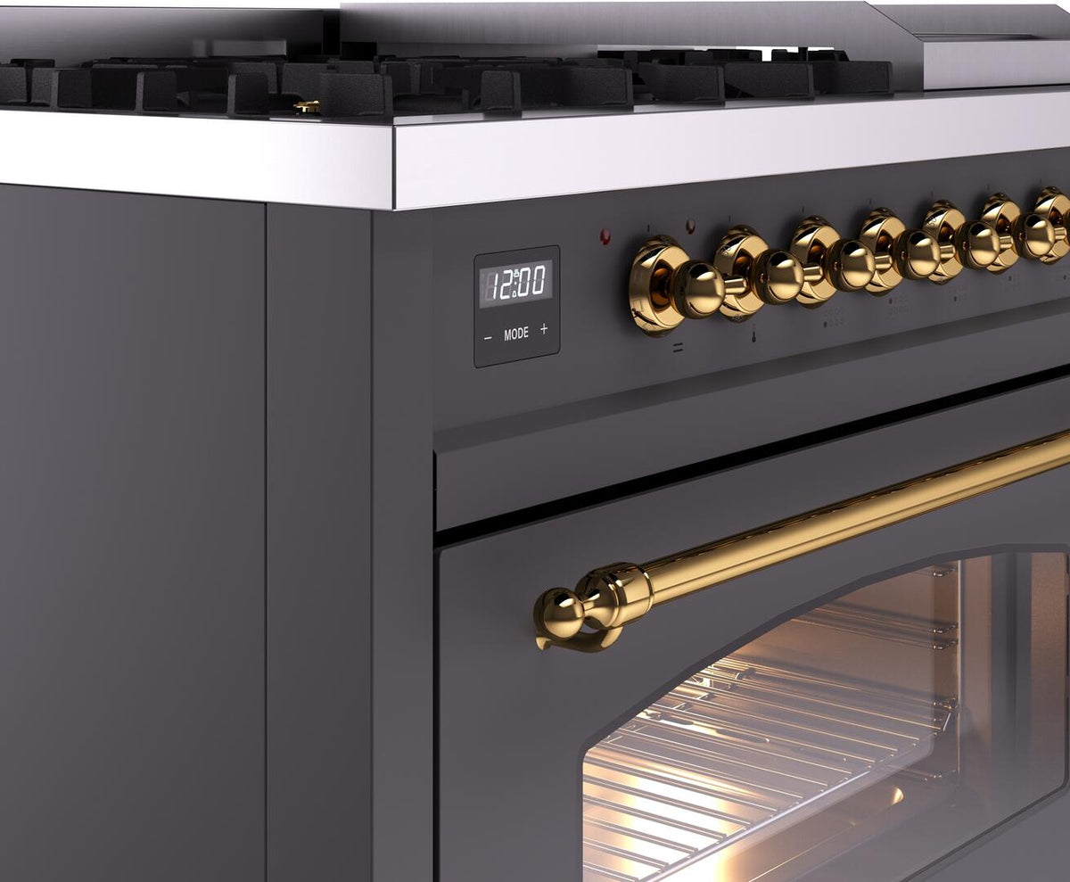 Freestanding dual fuel gas range control panel with brass knobs and digital display