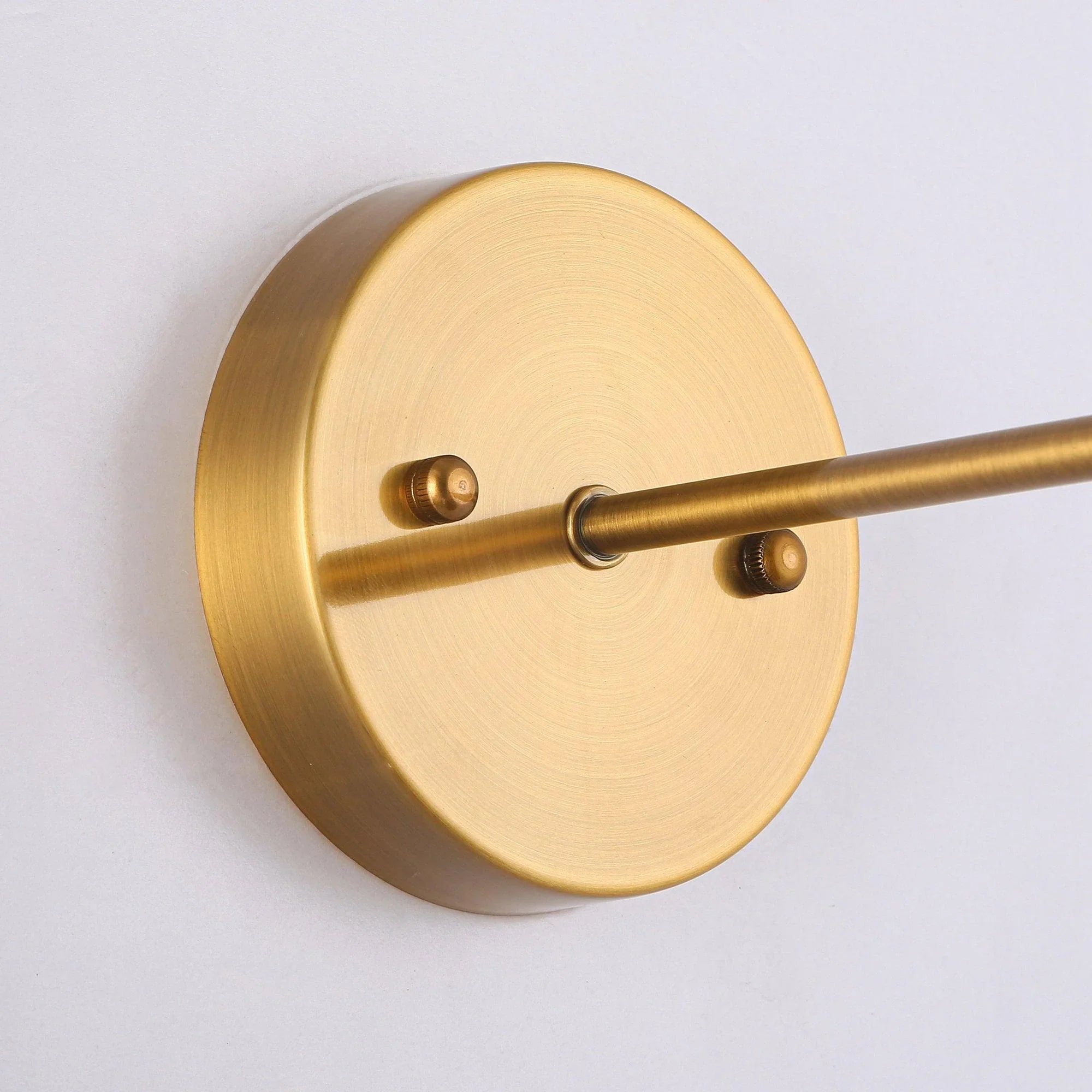 Golden brass round wall plate with mounting posts and connected sconce arm