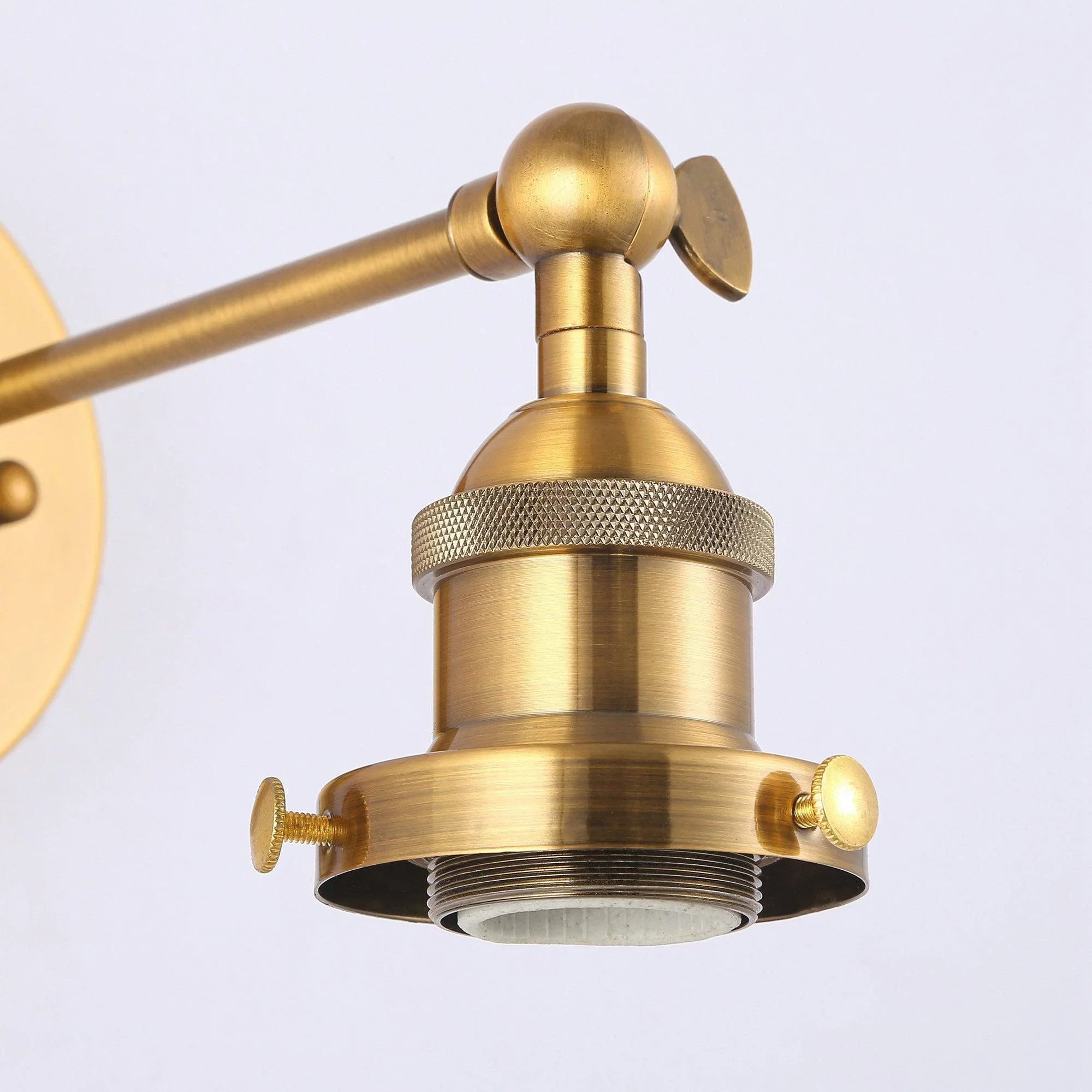 Golden brass wall sconce head with textured collar and round lamp base